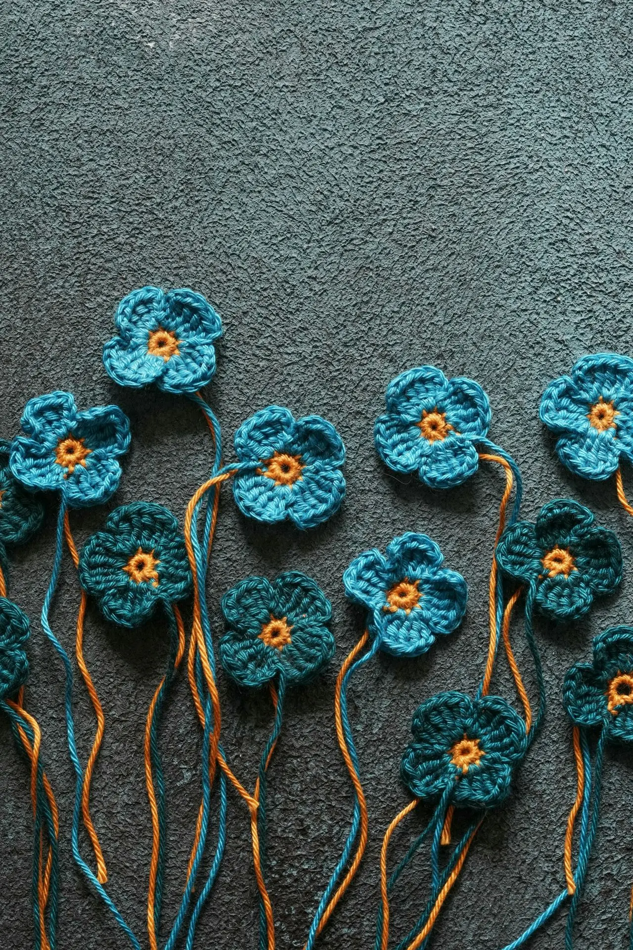 a group of crocheted flowers sitting on top of a carpet